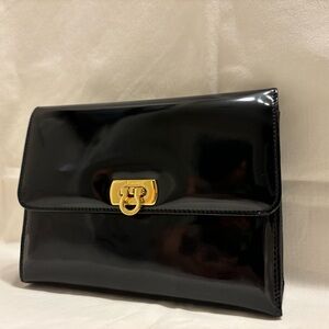 Salvatore Ferragamo , black patent leather clutch.